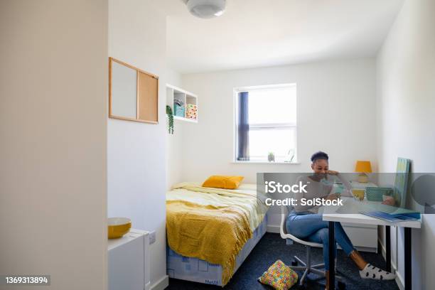 Relaxing In Her University Dorm Stock Photo - Download Image Now - Dorm Room, College Dorm, Desk
