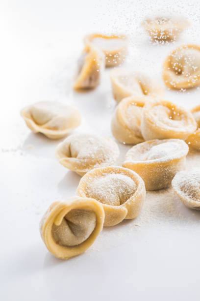 istock Raw fresh dumplings , or italian tortellini pasta, isolated on white background 1369314183