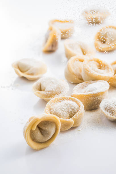 Raw fresh dumplings , or italian tortellini pasta, isolated on white background stock photo