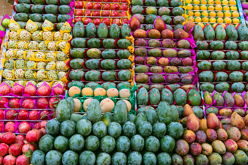 Colorful organic fruits in marketplace. Bright summer background. Healthy food. Street trading in Asia or Africa.