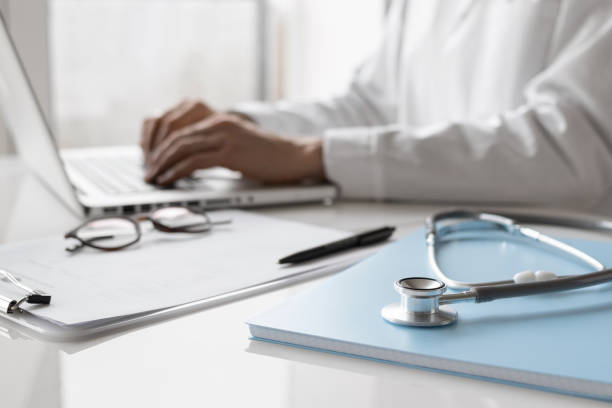 istock Doctor medical professional wearing uniform working on laptop computer 1369314350