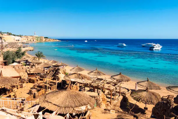 Sunny resort beach at the coast shore of Red Sea in Sharm el Sheikh, Sinai, Egypt, Asia in summer hot. Bright sunny light