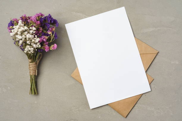 istock Flowers, blank paper and envelope on a table top 1369315085