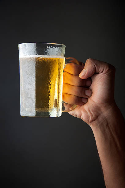 istock Glass of beer in hand 136931716