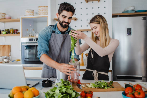 istock Young couple prepares a healthy drink 1369317891
