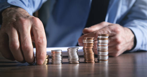 istock Male hand stacking coins. Saving money 1369320035