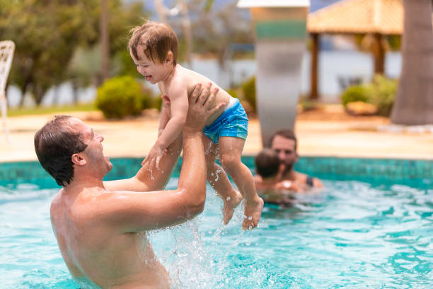 istock father playing with his son in the pool, narrow focus 1369320063