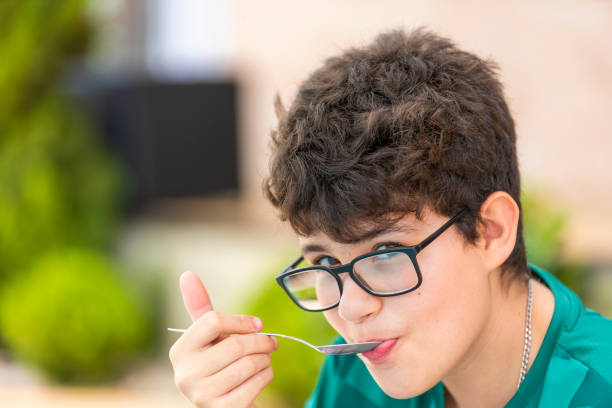 boy in glasses with a spoon, narrow focus