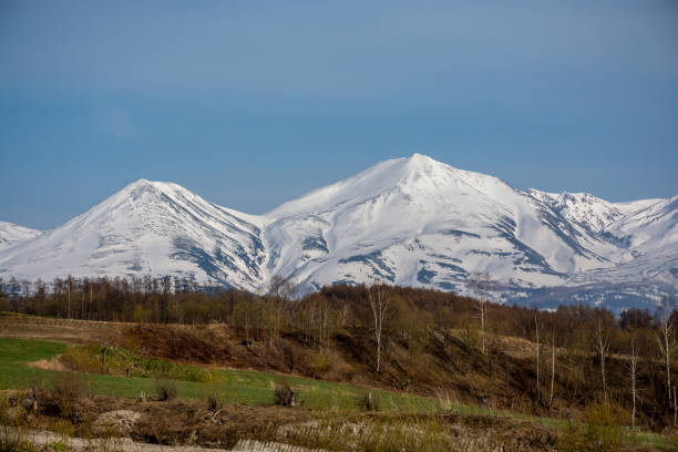 istock Spring hills and snowy mountains 1369321416