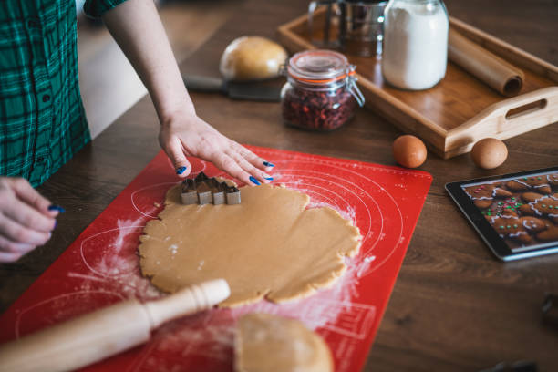 istock Woman making gingerbread cookies. 1369325807