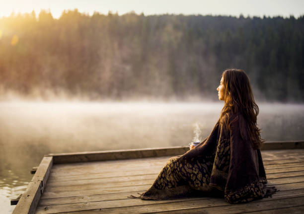 istock Woman relaxing with and coffee on sunrise. 1369325822