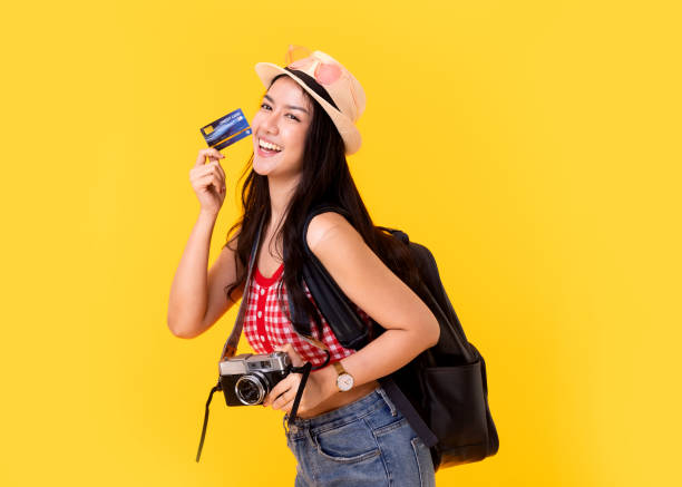 Tourist woman in summer casual clothes.Asian Smiling woman .Passenger traveling abroad to travel on yellow colour background.Asian woman going to summer vacation.Travel trip funny. Tourist woman in summer casual clothes.Asian Smiling woman .Passenger traveling abroad to travel on yellow colour background.Asian woman going to summer vacation.Travel trip funny. voyager 1 stock pictures, royalty-free photos & images