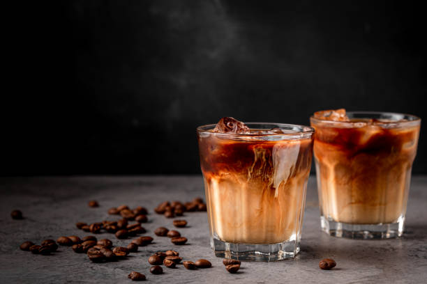 istock Ice coffee in a glass with cream poured over 1369329849