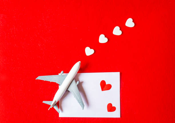 istock Hearts and a plane on a red background. Valentine's Day. Selective focus. 1369329901