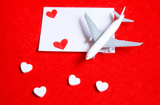 istock Hearts and a plane on a red background. Valentine's Day. Selective focus. 1369329904