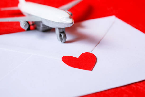 istock Hearts and a plane on a red background. Valentine's Day. Selective focus. 1369329920