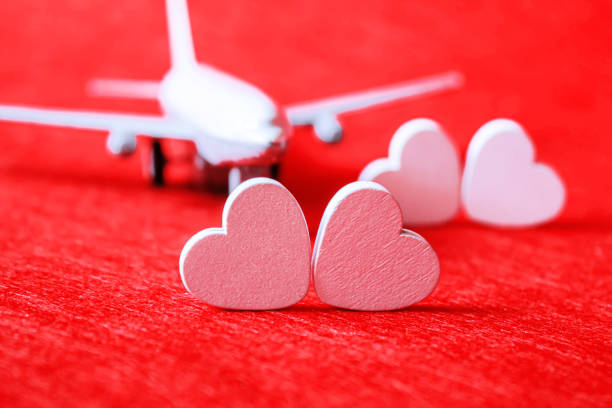 Hearts and a plane on a red background. Valentine's Day. Selective focus. Valentine.