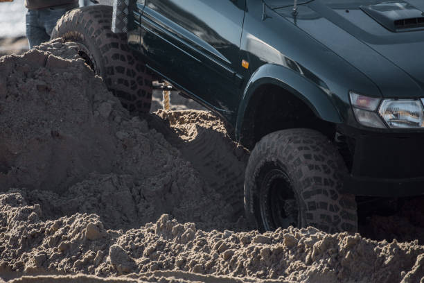 istock Offroad truck and other 4X4 vehicles on a sandy beach 1369330121