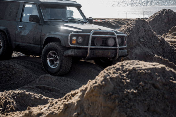 istock Offroad truck and other 4X4 vehicles on a sandy beach 1369330167