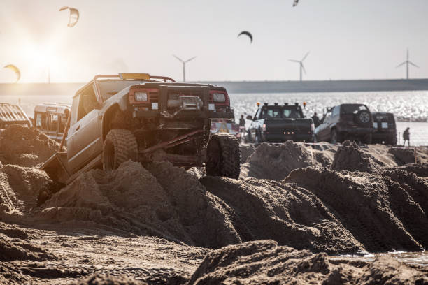 istock Offroad truck and other 4X4 vehicles on a sandy beach 1369330232