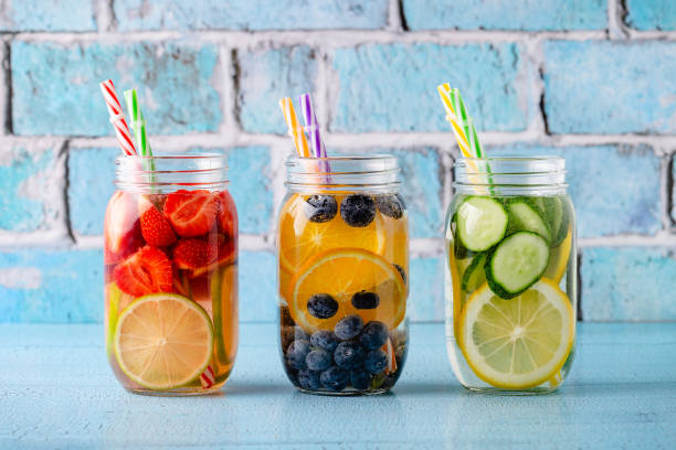 Healthy detox infused water with fruits. Healthy detox infused water with fruits. Refreshing summer homemade cocktail. infused water stock pictures, royalty-free photos & images