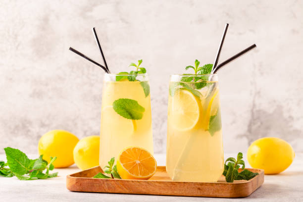 istock Lemonade with lemon, mint and ice cubes in glass 1369331674