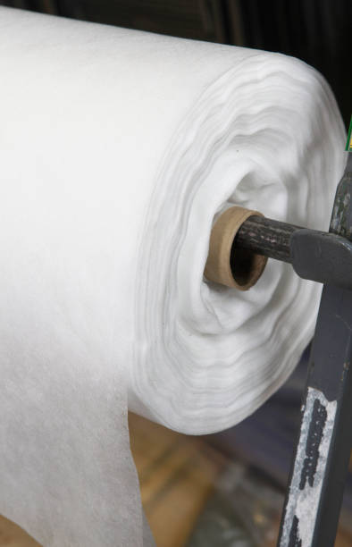 istock A close-up of a white polypropylene spunbond, nonwoven fabric roll. A large spunbond roll on sale. 1369331945