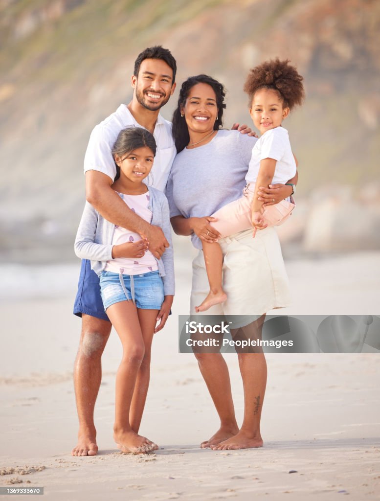 Shot of a beautiful young family of three spending the day together at the beach Family is the most important thing in the world Family Stock Photo