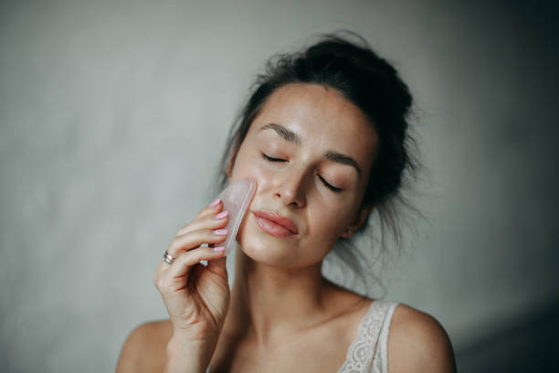 istock Brunette woman 30 years old doing face massage with a gouache scraper 1369334588