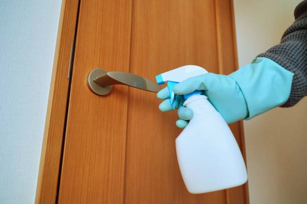 istock Alcohol disinfection image of doorknob using rubber gloves and spray 1369334630