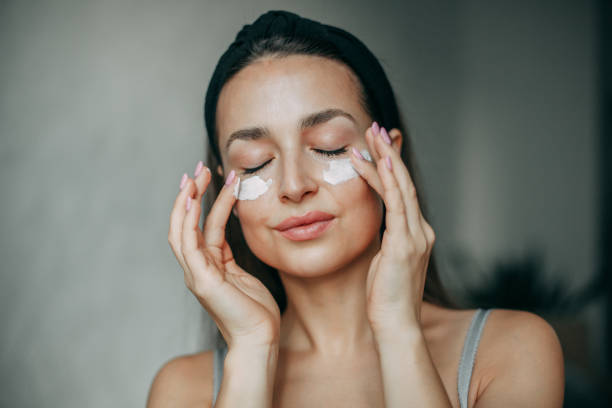 istock Brunette woman 30 years old with cream on her face 1369334977