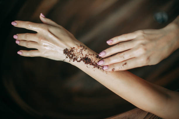 istock Woman applying coffee natural body scrub on hand 1369334987