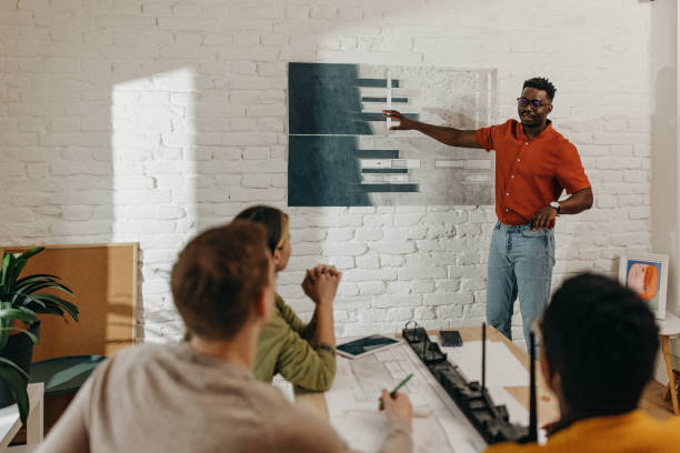 istock African-American architect presents project to a group of students 1369335204