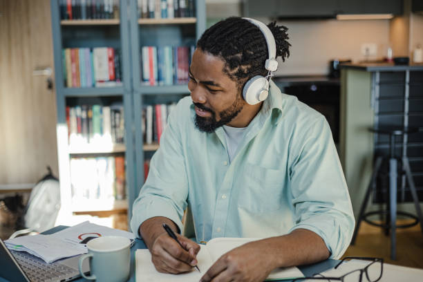 istock Man attends an online course at home 1369335393