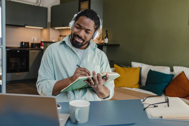 istock Man attends an online course at home 1369335672