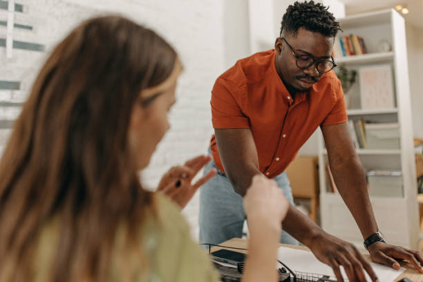 istock African-American architect presents project to a student 1369335923