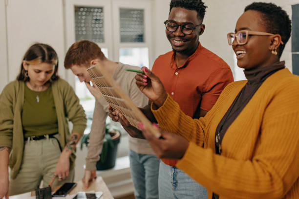 istock Group of architect students working on a new project 1369336339