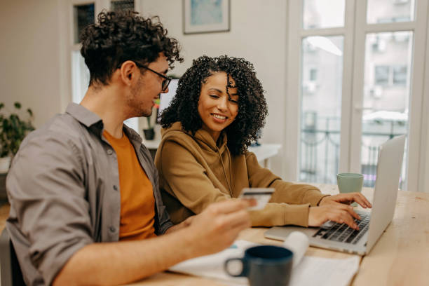 istock Young couple using laptop and making online shopping 1369337409