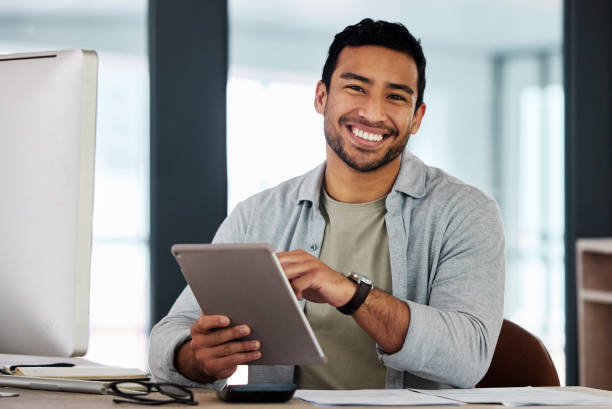 istock Shot of a young businessman using his digital tablet 1369338495