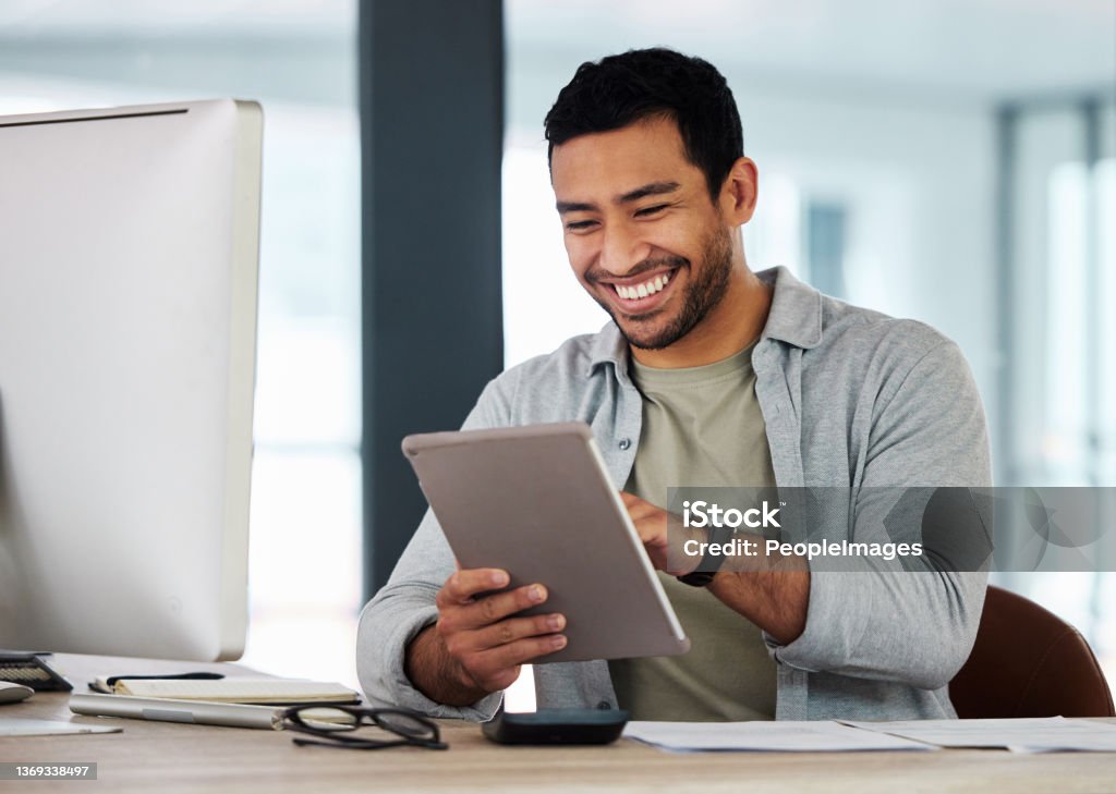 Shot of a young businessman using his digital tablet Master of my field Men Stock Photo