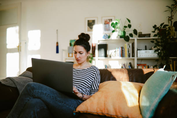 istock woman working from home at the sofa 1369340072