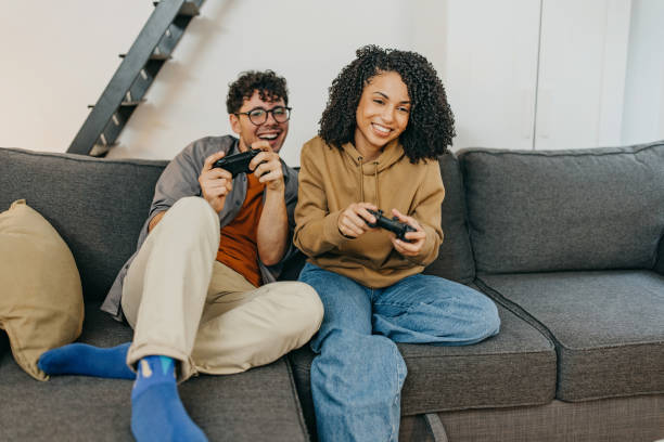 istock Young couple enjoy and having fun playing video games 1369340125