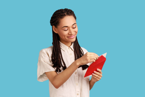 woman standing open red envelope with congratulations, reading romantic letter. - opening mail letter envelope imagens e fotografias de stock