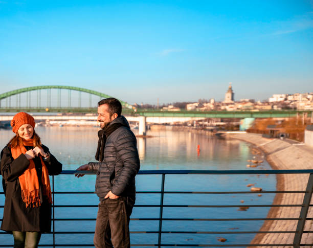 istock Flirting couple on the city bridge 1369344302