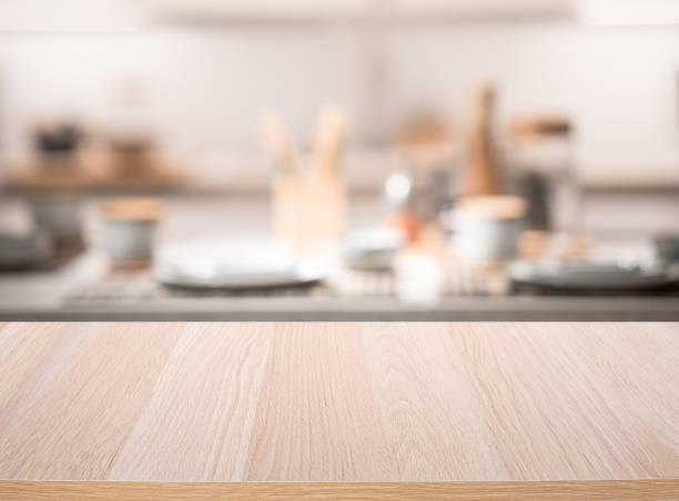 istock Selective focus.Wood table top on blur kitchen counter background. 1369344376