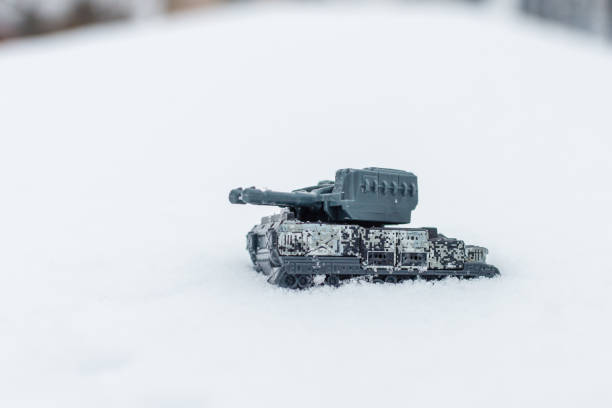 Miniature toy war tank on the winter snow.Selective focus,copy space.Outdoors shot.