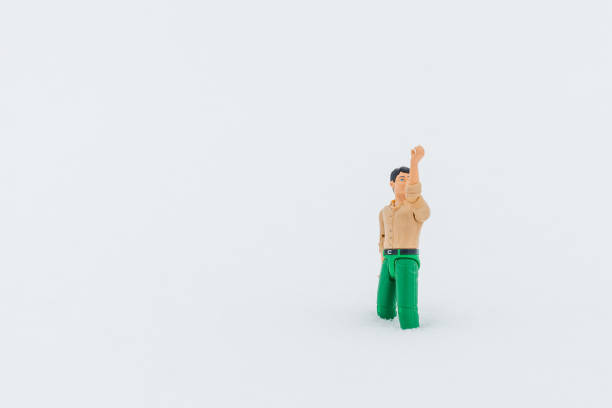 istock Miniature toy man holding something, white snow background.copy space.Outdoors shot. 1369347435