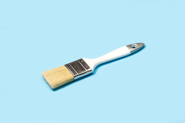 istock Wooden white paintbrush on a light blue background 1369347526