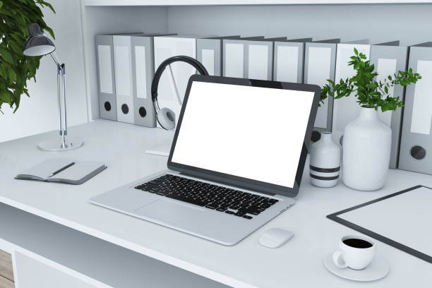istock Close up of creative designer desk top with folders bookcase, empty laptop screen, coffee cup, decorative plant and other items. Mock up, 3D Rendering. 1369347760