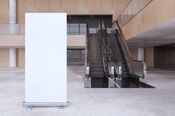 istock Modern wooden and concrete empty shopping mall interior with empty white mock up banner, escalator. Large public interiors concept. 3D Rendering. 1369348170